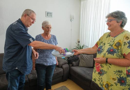 John en Willie van der Zwaan ontvangen de button van coördinator Petra de Visser van Stichting Manteling.