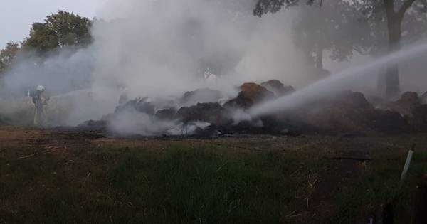 Brand in berg hout en afval langs kanaal in Delden